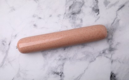 Photo of Delicious liver sausage on white marble table, top view