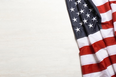 American flag on white wooden background, top view with space for text