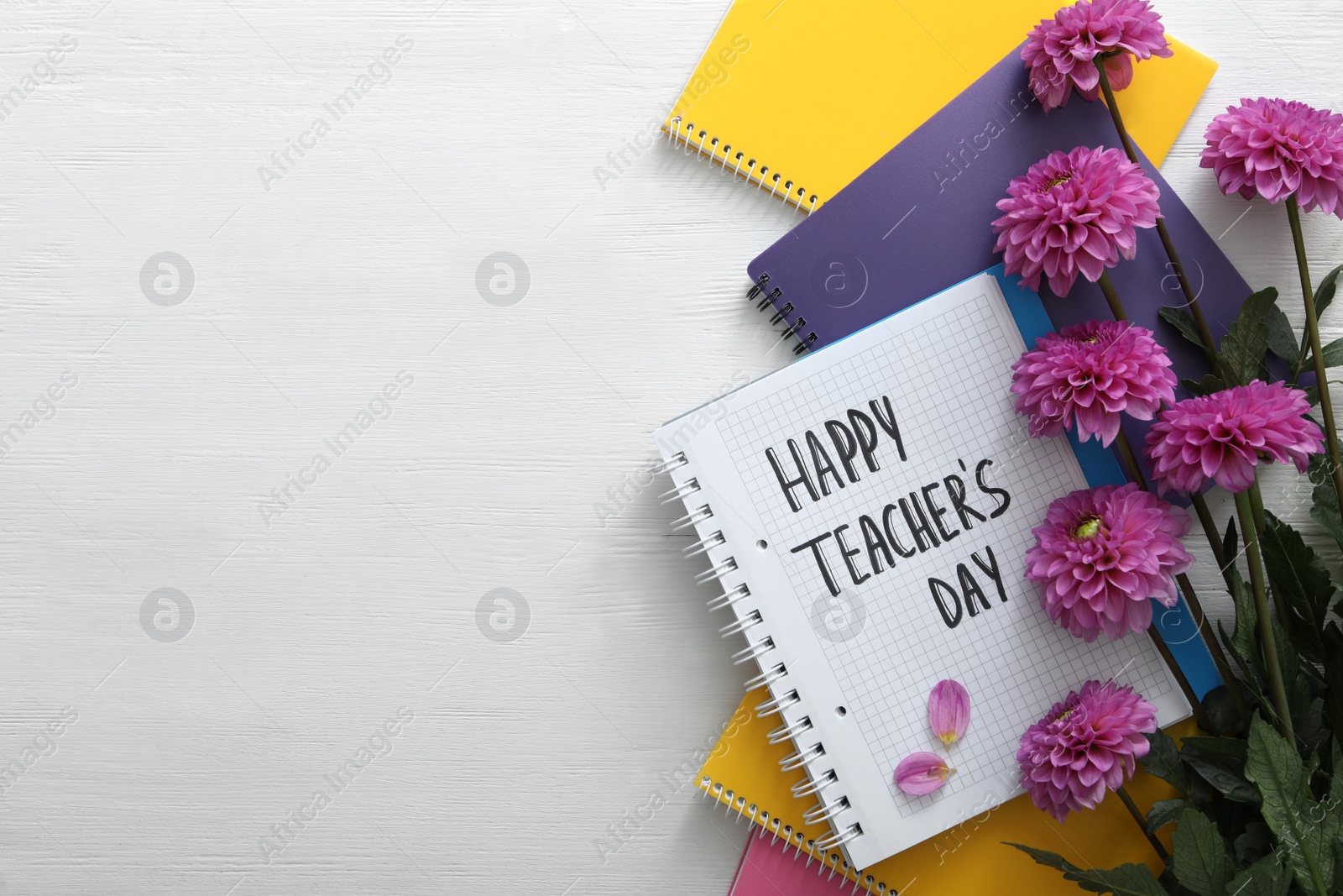 Photo of Flat lay composition with words HAPPY TEACHER'S DAY, notebooks and flowers on white wooden background. Space for text