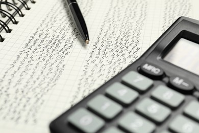 Photo of Calculator and pen on notebook with data, closeup view