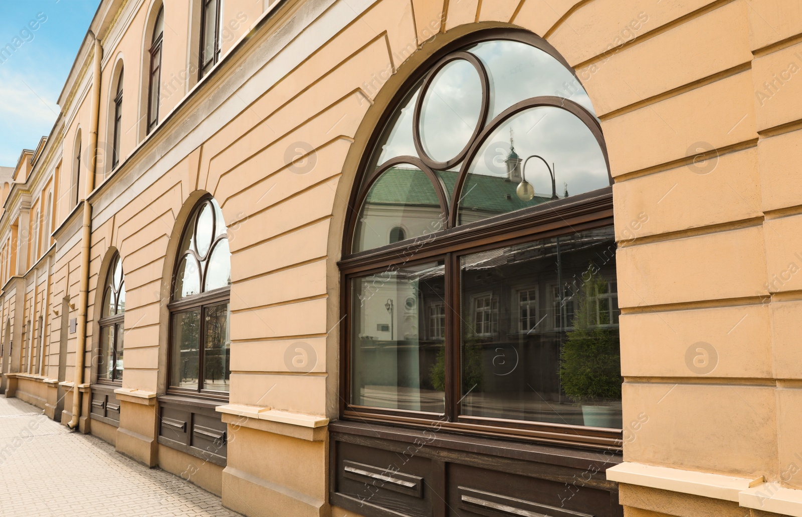 Photo of Building with beautiful wooden arch windows on city street