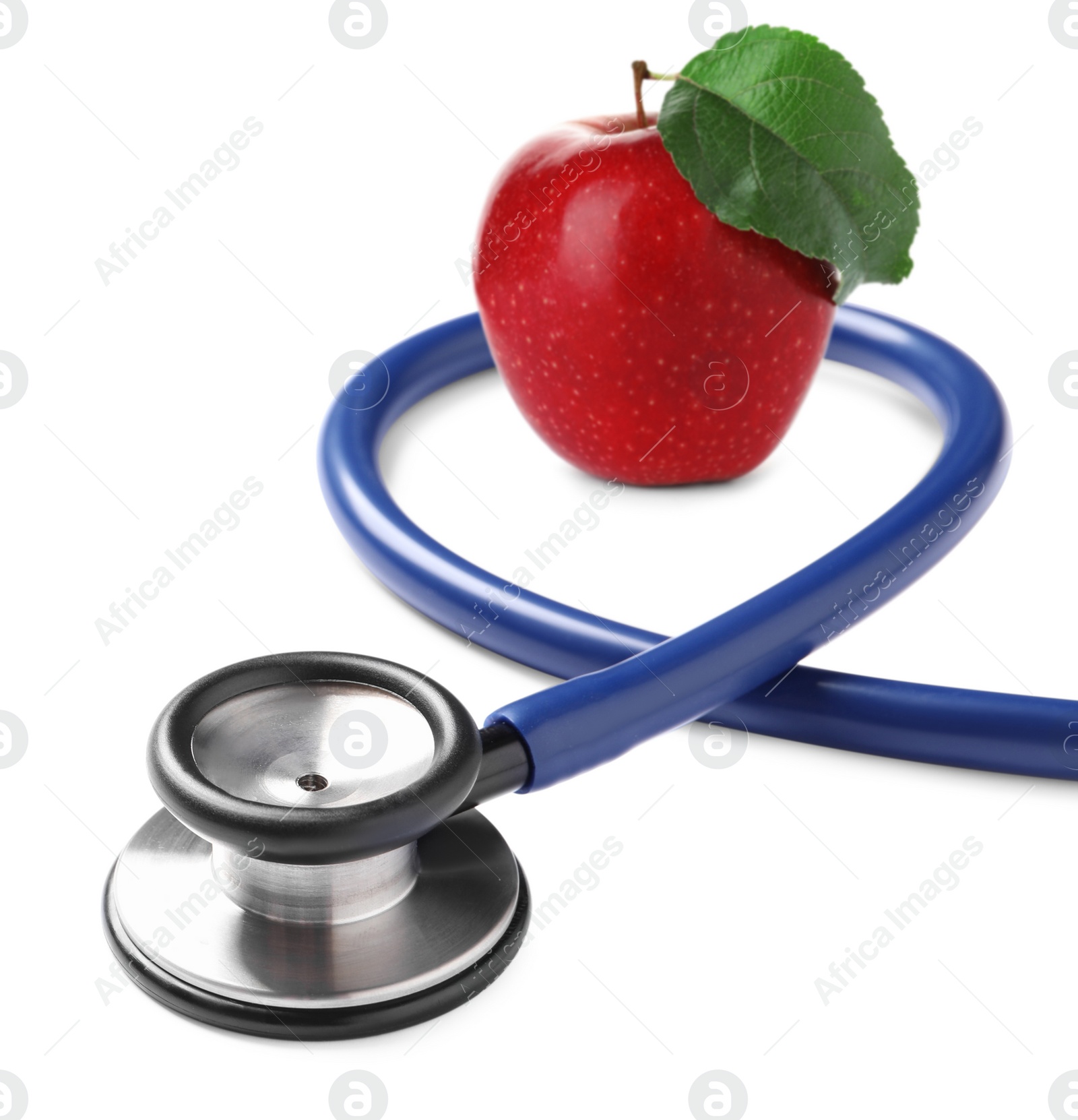 Image of Stethoscope and red apple on white background 