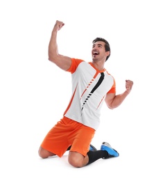 Young football player celebrating scoring of goal on white background