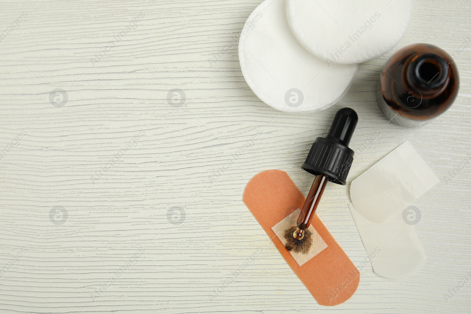 Photo of Flat lay composition with bottle of medical iodine on white wooden table. Space for text