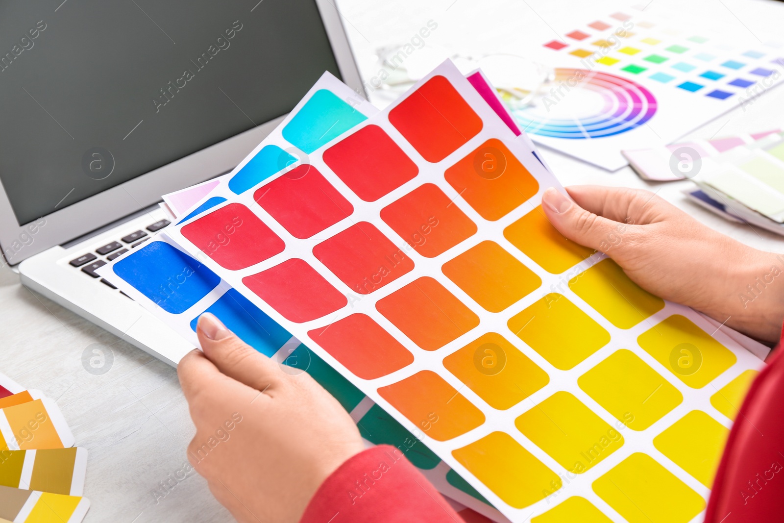 Photo of Woman with palette samples at white table, closeup