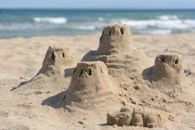 Photo of Beach with sand castle near sea on sunny day