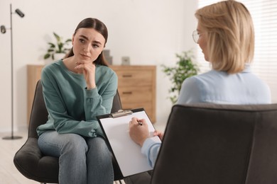 Photo of Professional psychotherapist working with patient in office