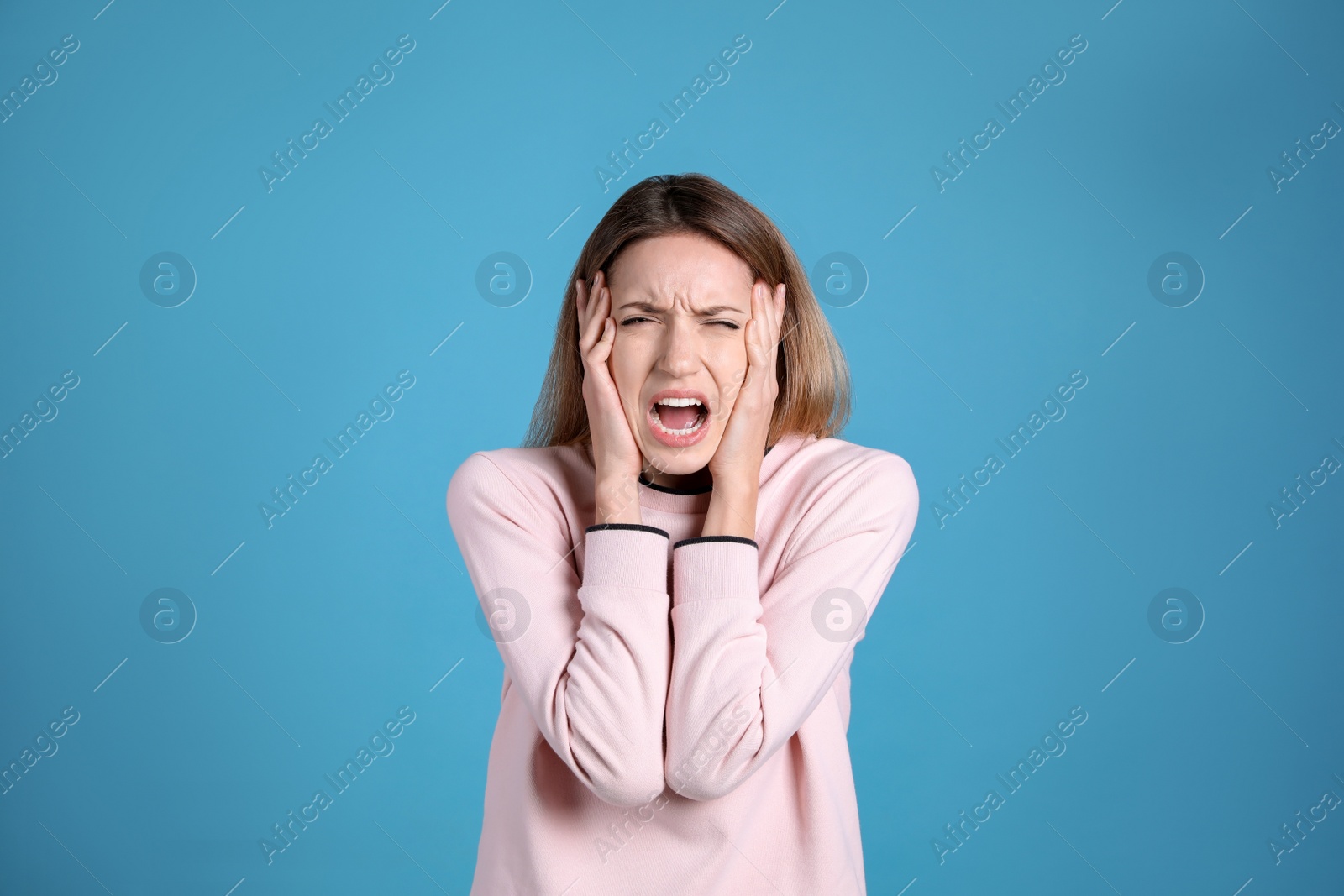 Photo of Portrait of stressed young woman on light blue background