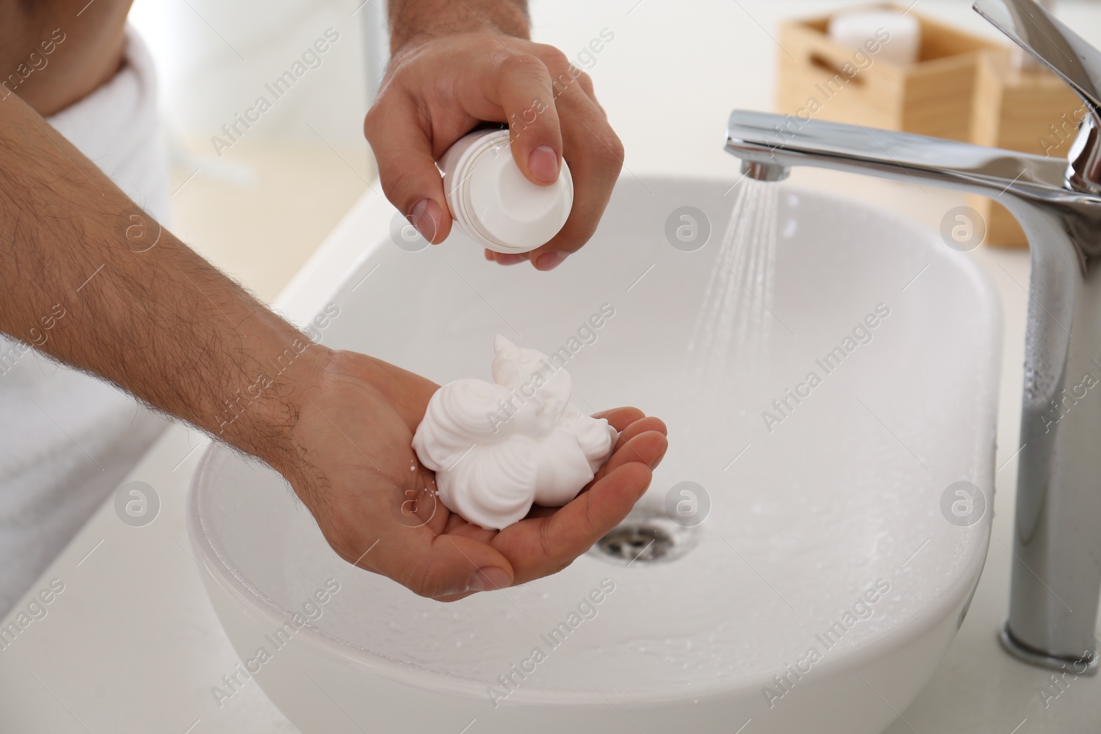 Photo of Man with shaving foam in bathroom, closeup