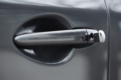 Closeup view of car door with key in lock