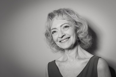 Image of Portrait of mature woman on light background. Black and white photography