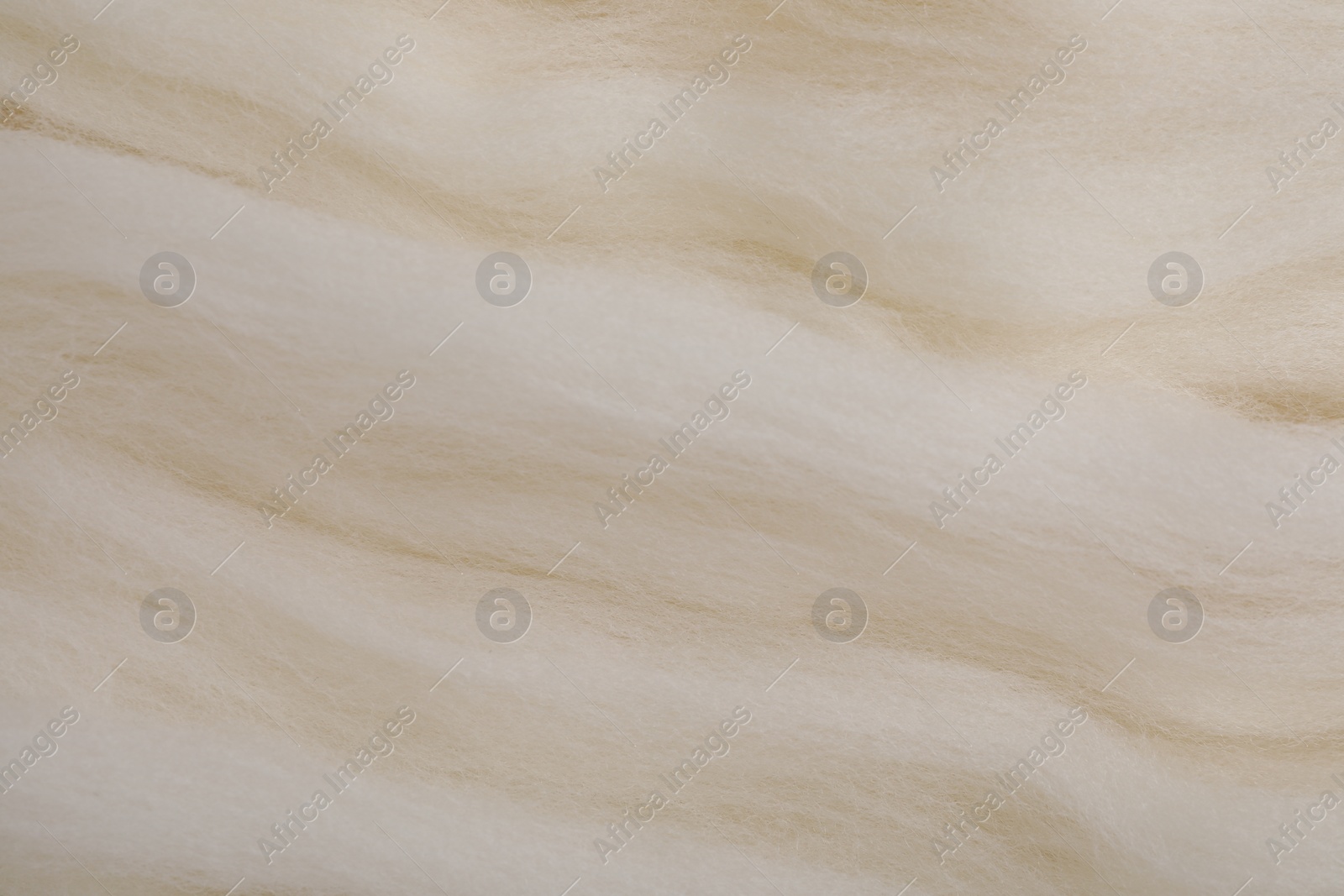 Photo of White felting wool as background, closeup view