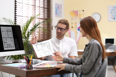 Photo of Interior designer consulting young woman in office
