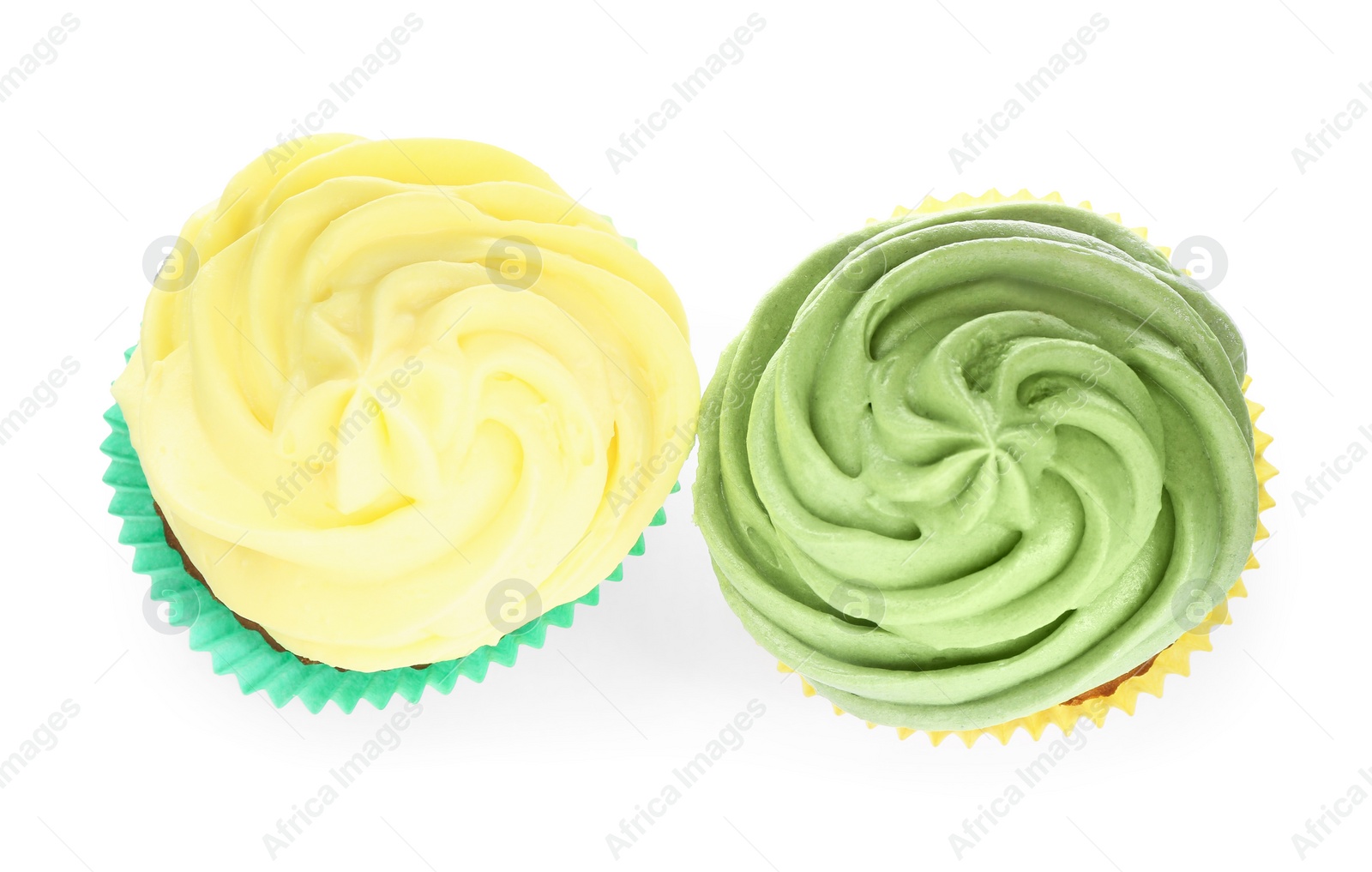 Photo of Different tasty cupcakes with cream isolated on white, top view