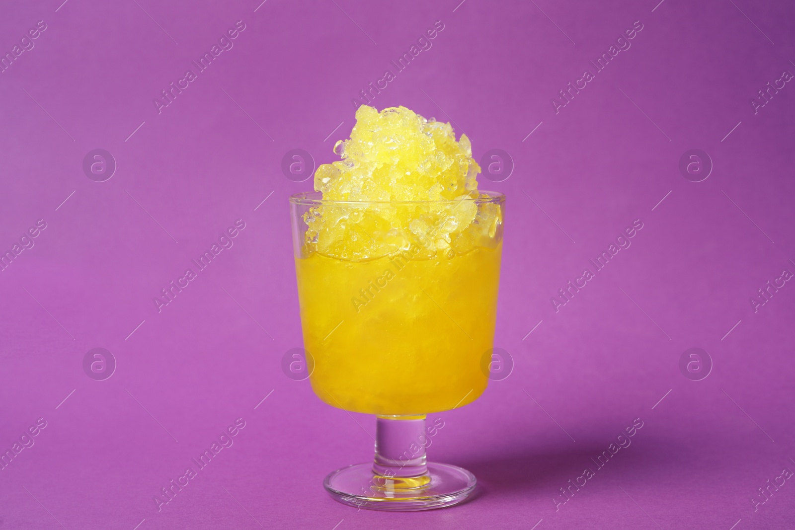 Photo of Shaving ice in glass dessert bowl on violet background