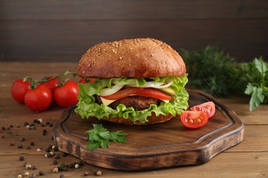 Photo of Delicious vegetarian burger served on wooden table