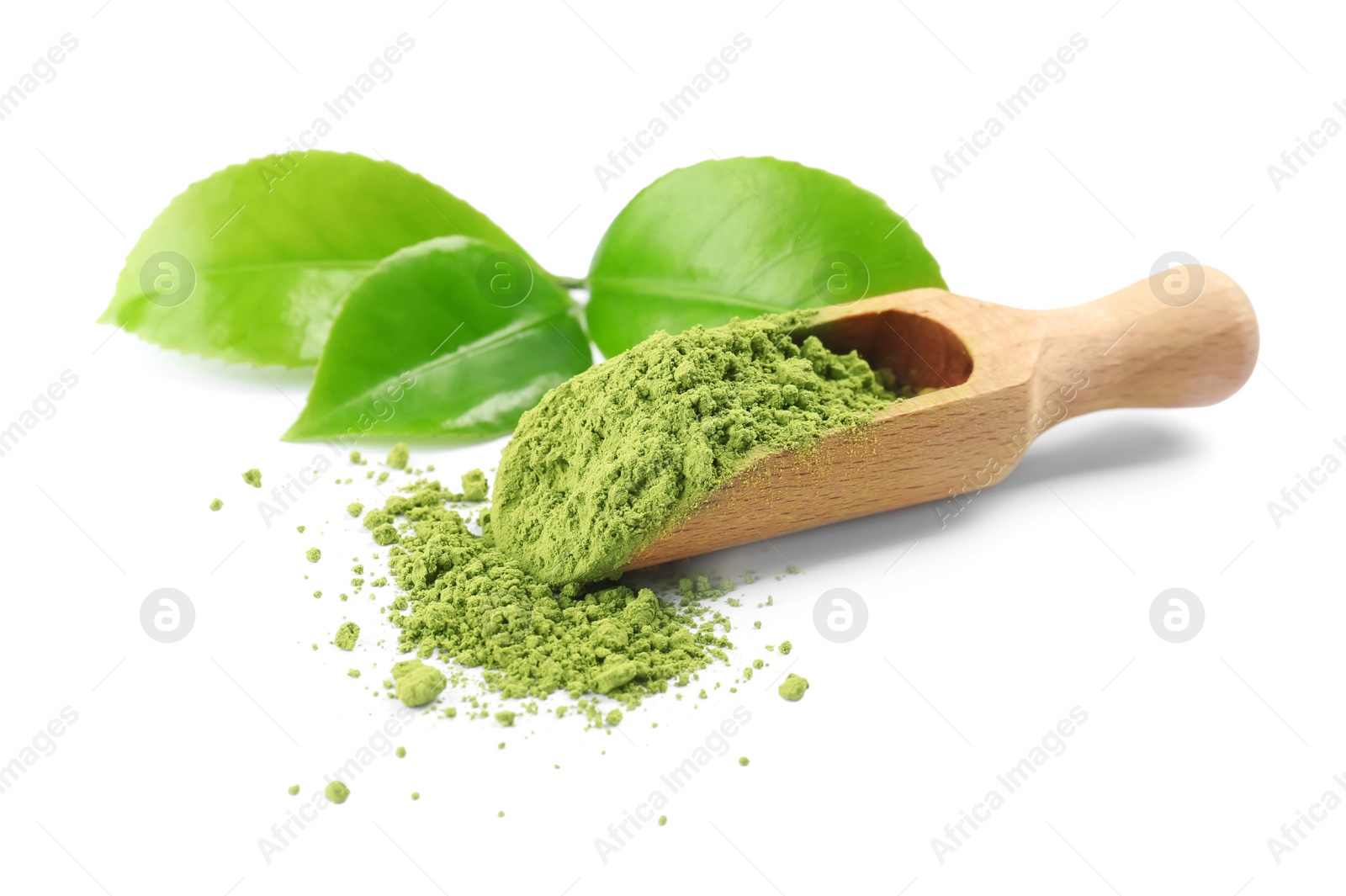 Photo of Scoop with powdered matcha tea and green leaves on white background