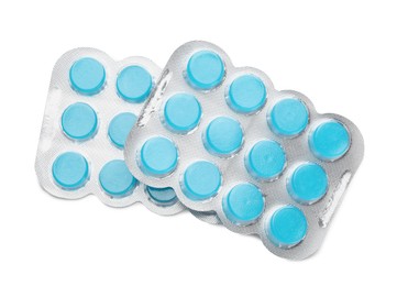 Photo of Blisters with blue cough drops on white background, top view