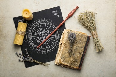 Photo of Flat lay composition with magic wand and divination cloth on light textured background