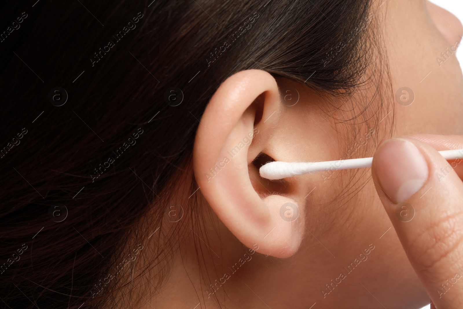 Photo of Woman cleaning ear with cotton swab, closeup