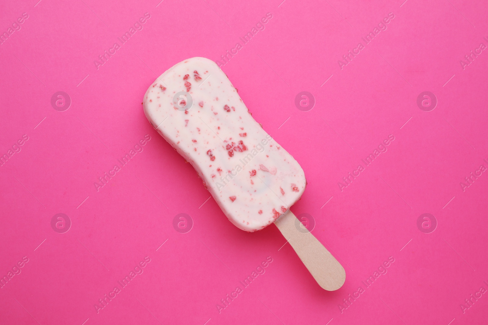 Photo of Delicious glazed ice cream bar on pink background, top view