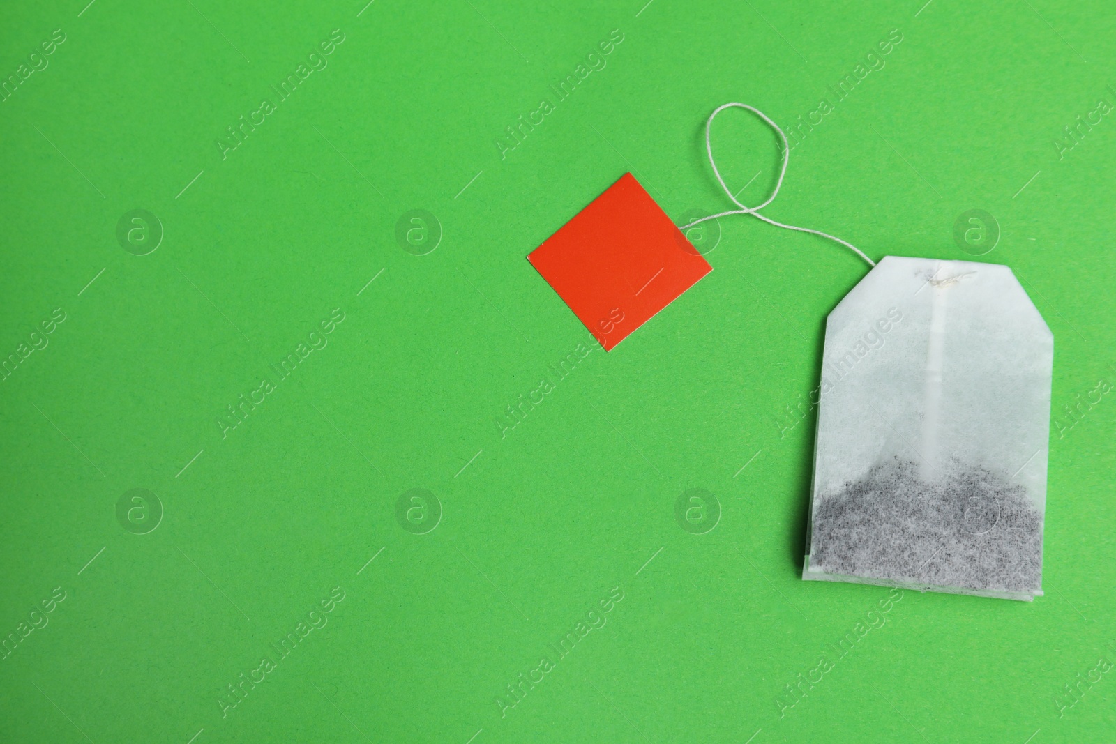 Photo of Tea bag on color background, top view with space for text