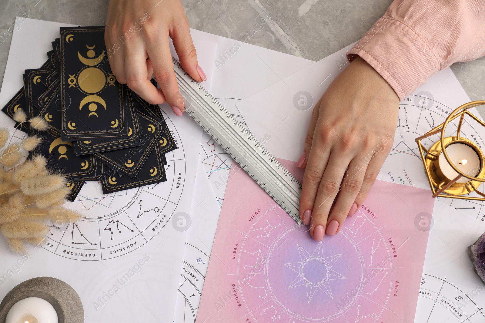 Photo of Astrologer using zodiac wheel for fate forecast at table, top view. Fortune telling