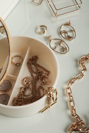 Photo of Jewelry box with stylish golden bijouterie on table, closeup