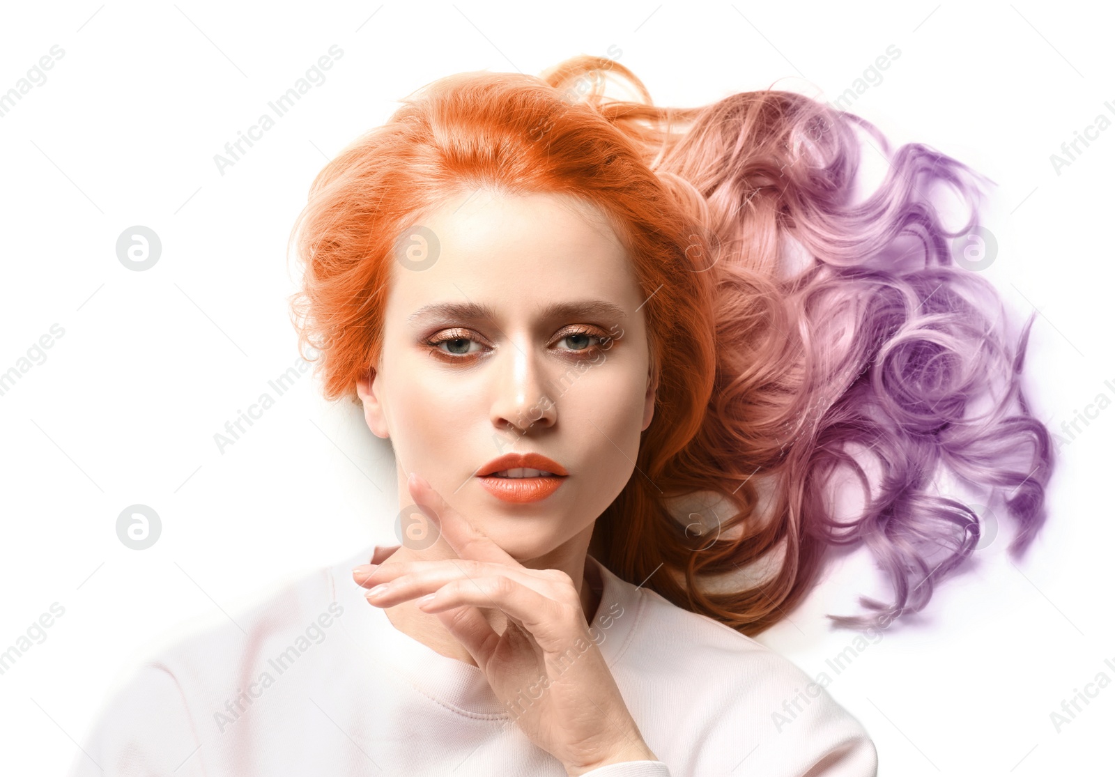 Image of Portrait of young woman with dyed long curly hair on white background