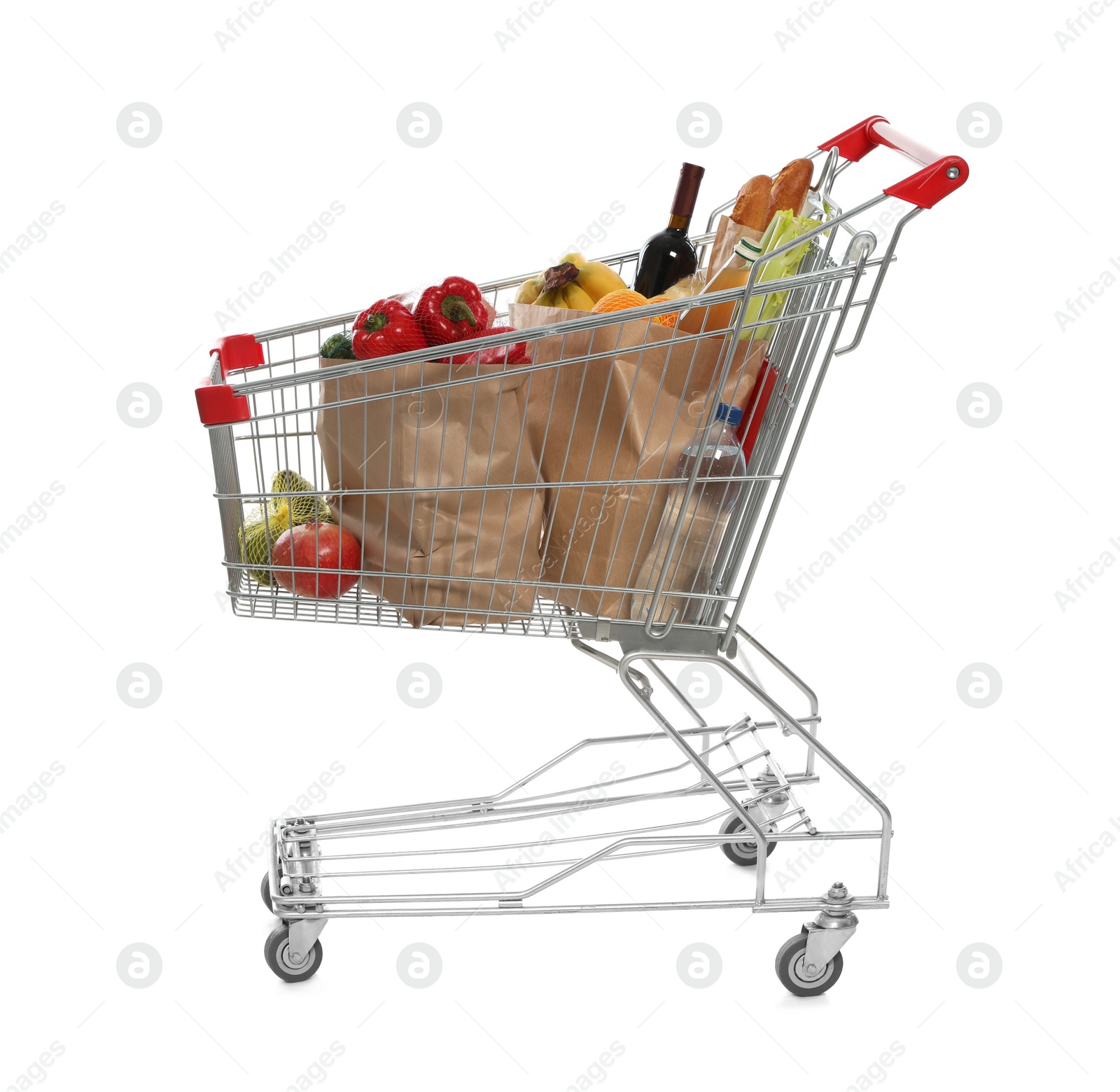 Photo of Shopping cart full of groceries on white background