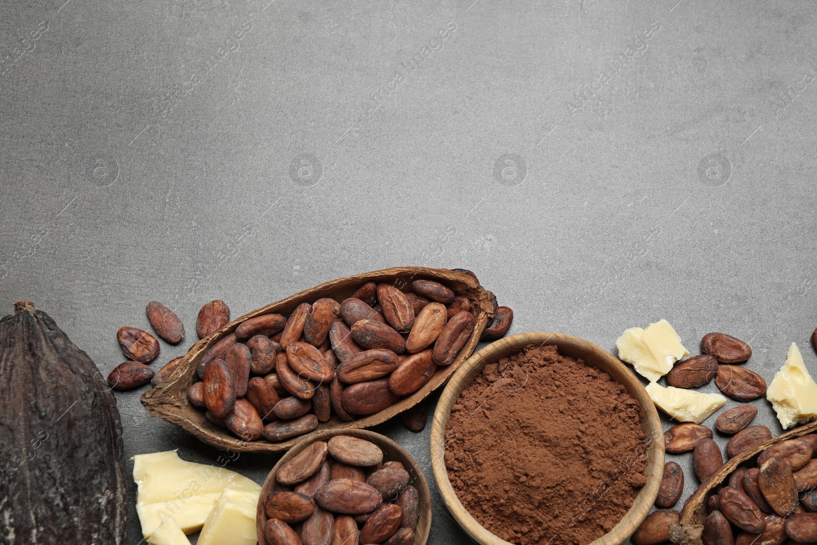 Photo of Flat lay composition with organic cocoa butter on grey table. Space for text