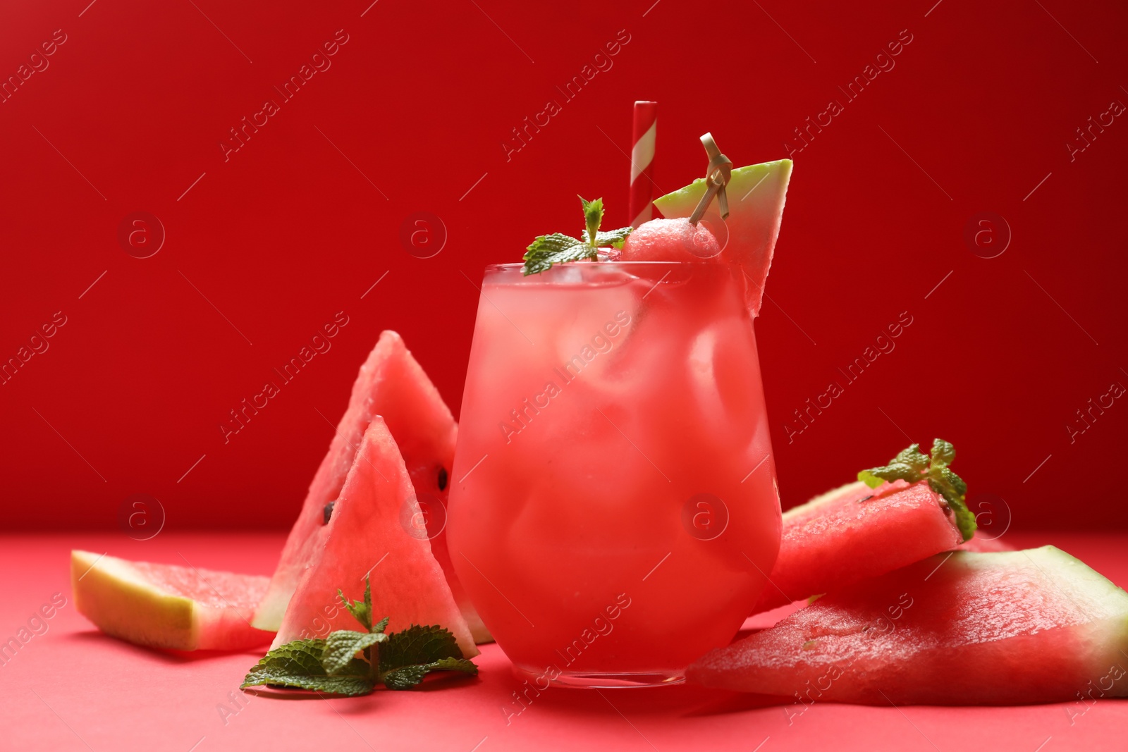 Photo of Tasty watermelon drink and fresh fruits on red background