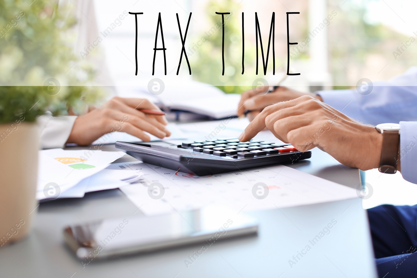 Image of Tax accountants working with documents at table, closeup