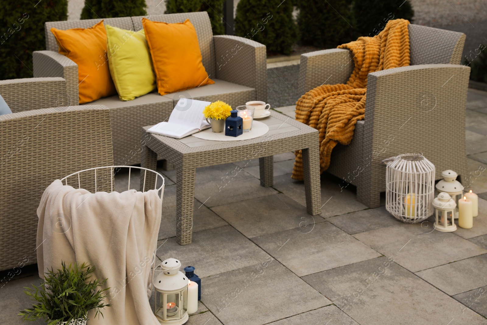 Photo of Beautiful rattan garden furniture, soft pillows and different decor elements outdoors