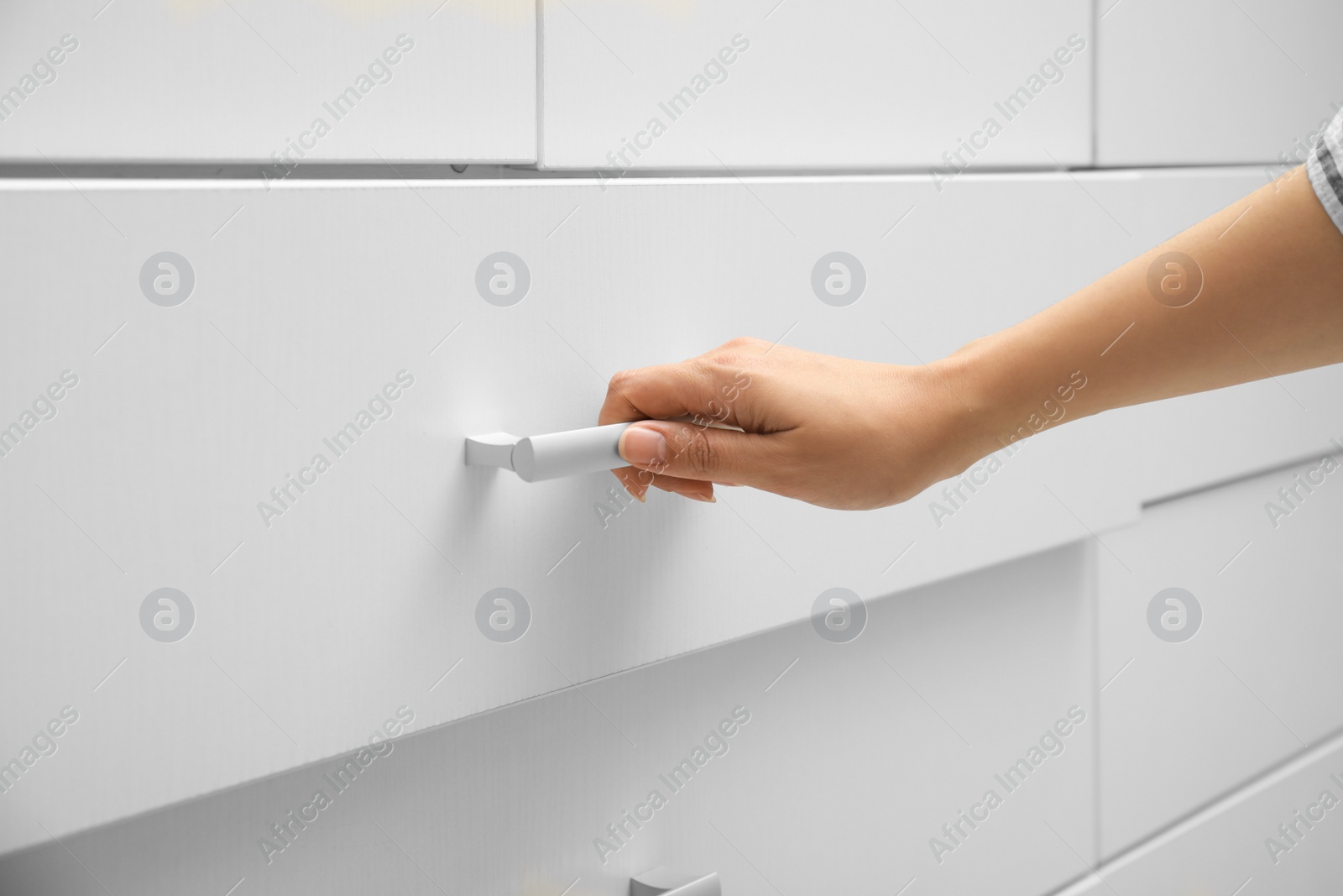 Photo of Woman opening drawer at home, closeup view