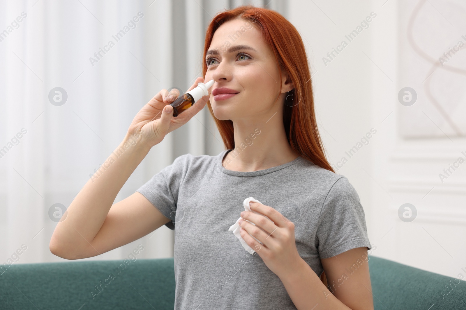 Photo of Medical drops. Woman with tissue using nasal spray at home