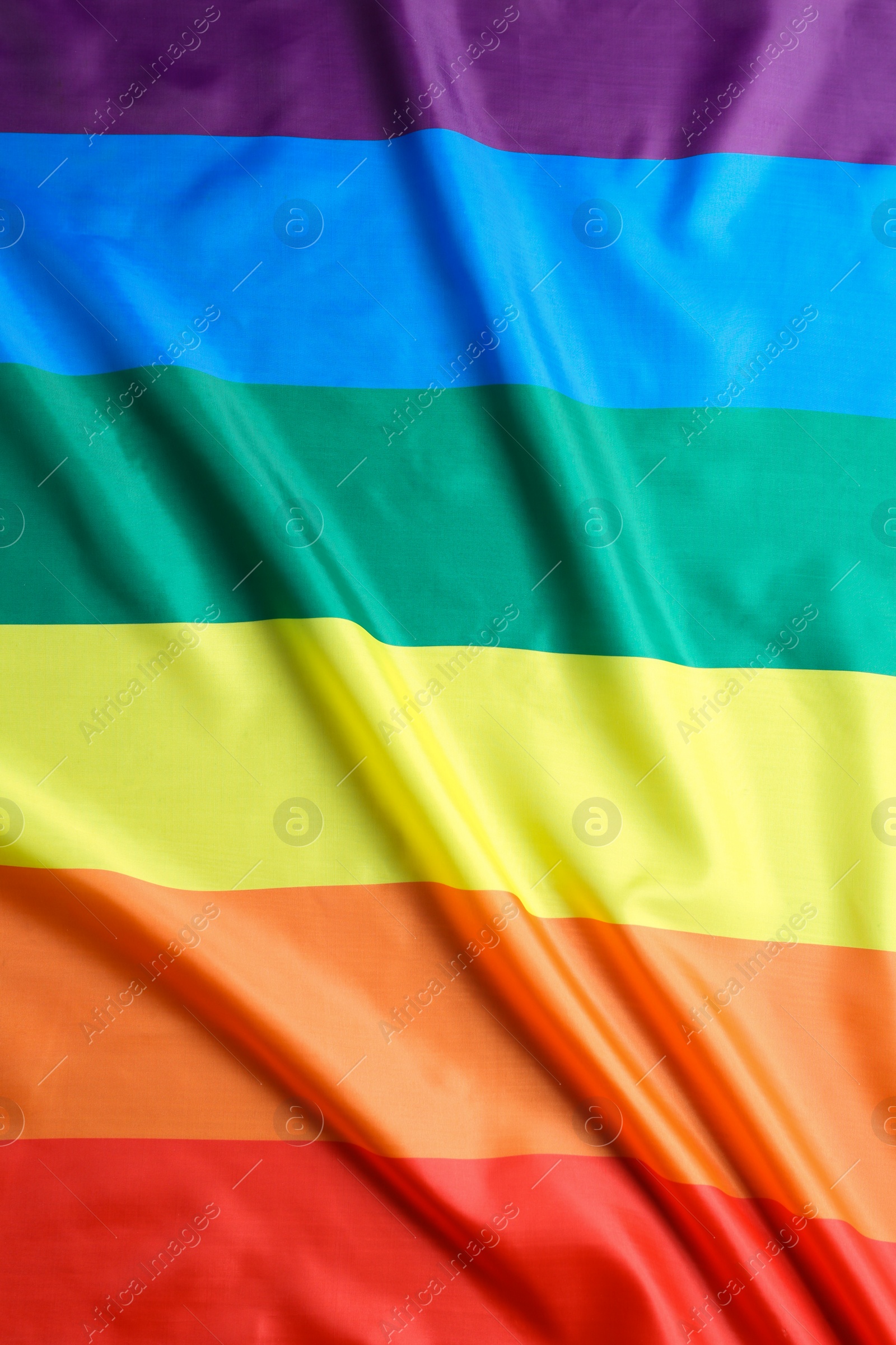 Photo of Bright rainbow gay flag as background. LGBT community