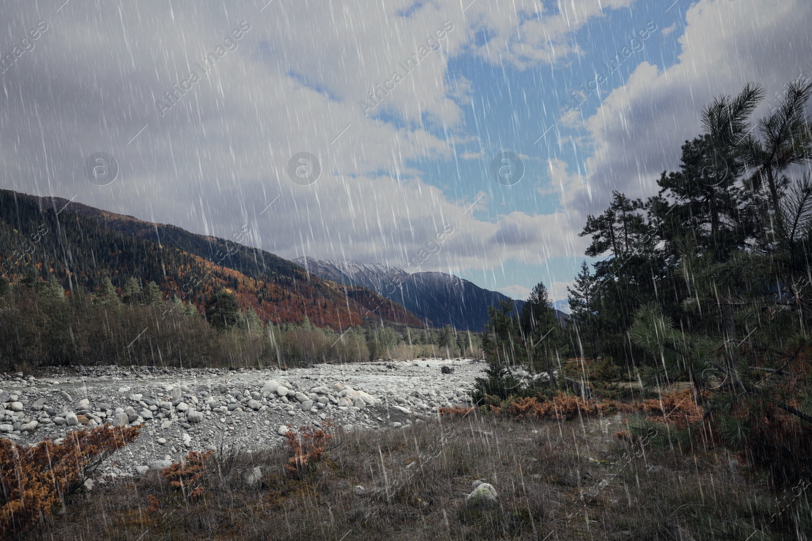 Image of Picturesque view of river in mountains on rainy day