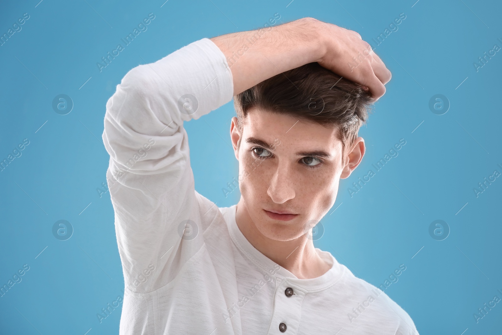 Photo of Portrait of young man with beautiful hair on color background