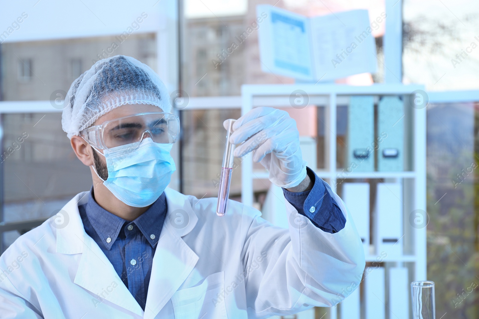 Photo of Young scientist working with test tube in laboratory. Chemical analysis