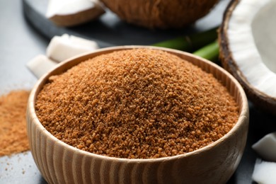 Natural coconut sugar in wooden bowl, closeup