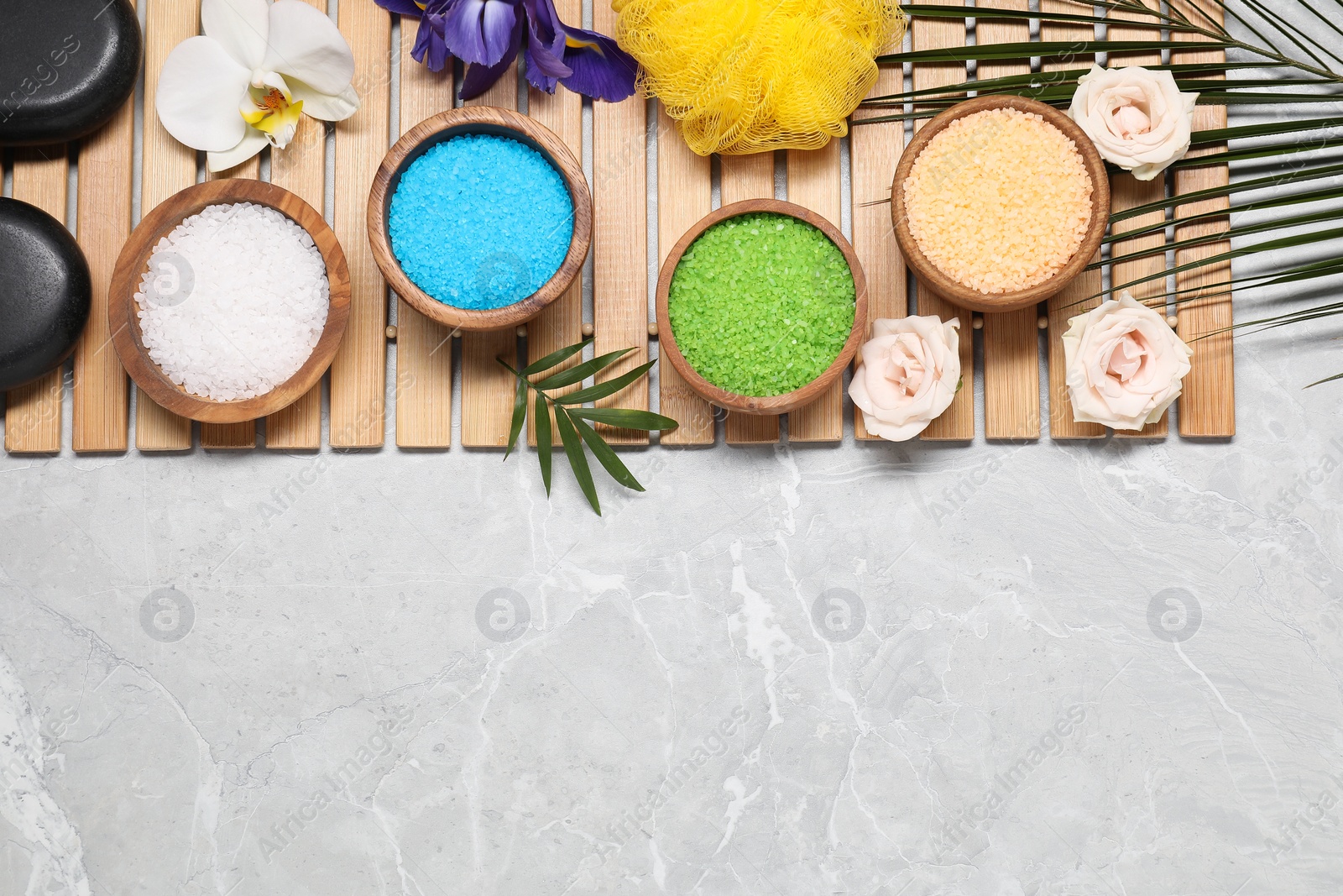 Photo of Flat lay composition with natural sea salt on grey marble table. Space for text