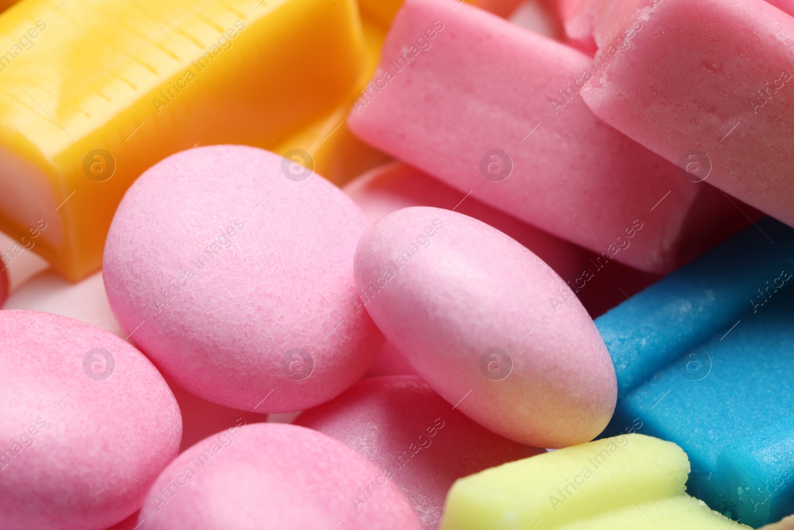 Photo of Different tasty colorful bubble gums as background, closeup