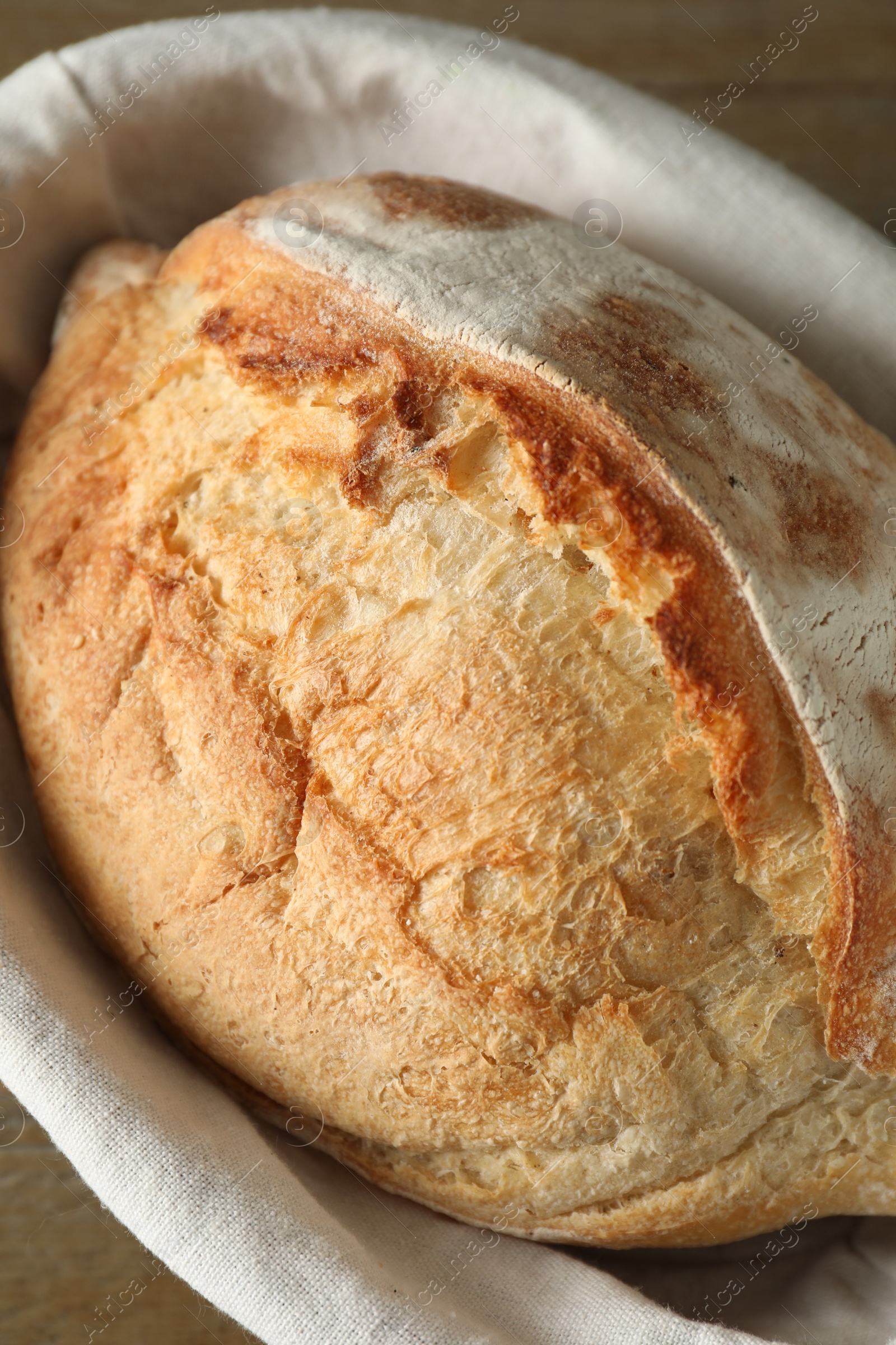 Photo of Basket with fresh bread on table, closeup