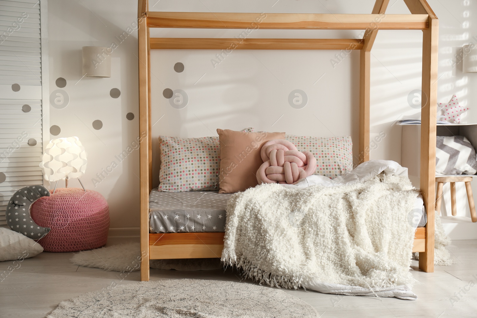 Photo of Cozy child room interior with comfortable bed