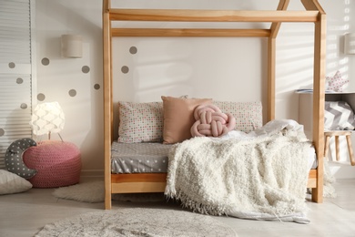 Cozy child room interior with comfortable bed