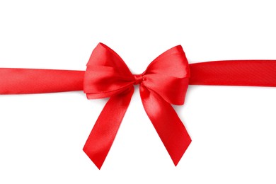 Red bow and ribbon on white background, top view