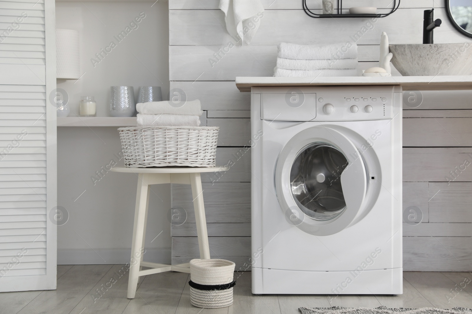 Photo of Stylish bathroom interior with modern washing machine