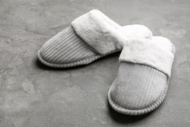 Photo of Pair of soft slippers on grey background