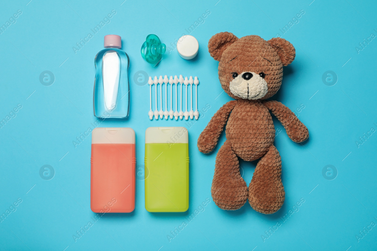 Photo of Flat lay composition with baby cosmetic products on light blue background